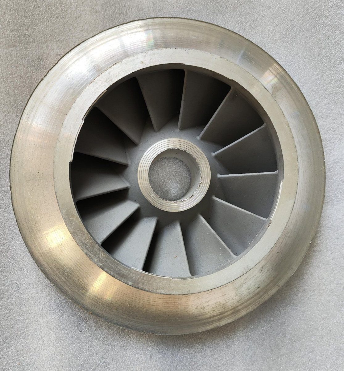 Closed impeller for a metallic centrifugal pump showing the shrouded vanes and threaded hub bore