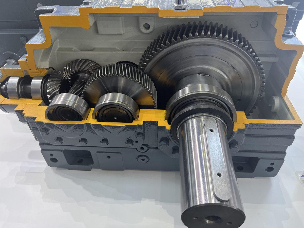 Cut away gear reducer showing the helical gear train, bearings and output shaft inside the housing
